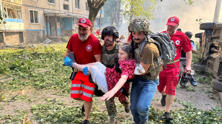 Paramedics carry a person rescued from an apartment building after a Russian air strike in  Kharkiv.
Pic: Reuters