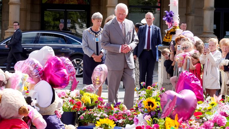 King Charles views the tributes outside the Atkinson Art Centre in Southport.
Pic: PA