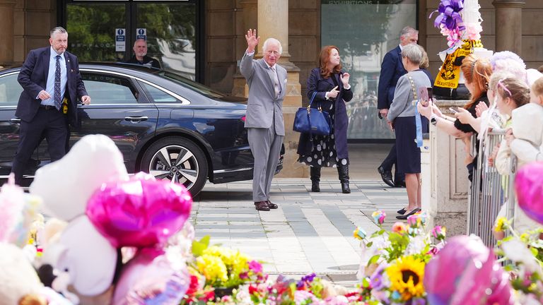 King Charles views the tributes outside the Atkinson Art Centre in Southport.
Pic: PA