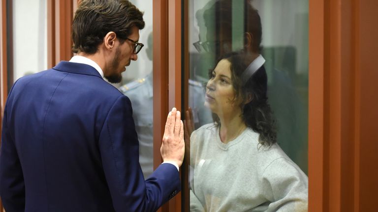 Karelina speaking to her lawyer in court. Pic: AP