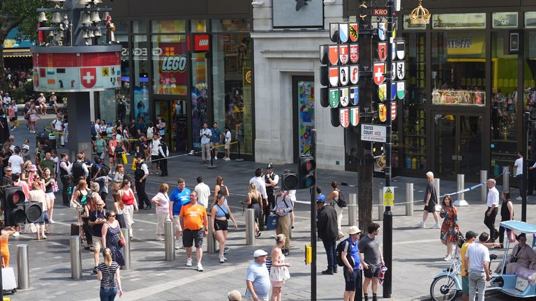 Police officers at the scene in Leicester Square, London, as a man has been arrested after an 11-year-old girl and 34-year-old woman were stabbed. Picture date: Monday August 12, 2024.
