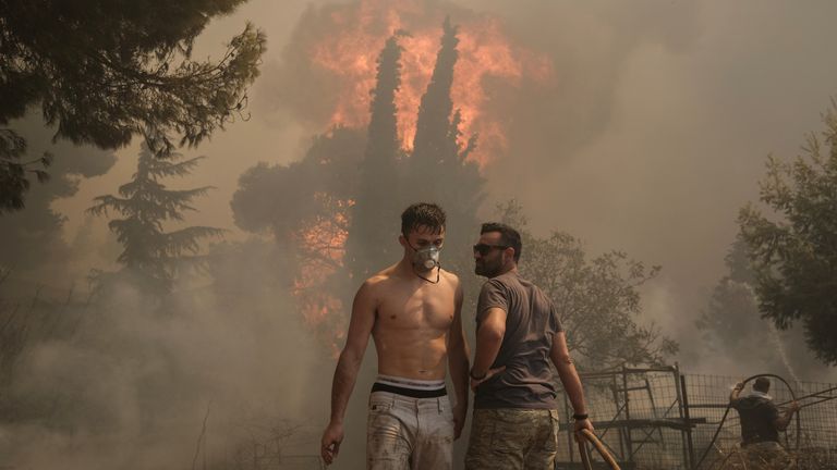 Volunteers try to extinguish a wildfire burning in Nea Pentel.
Pic: Reuters