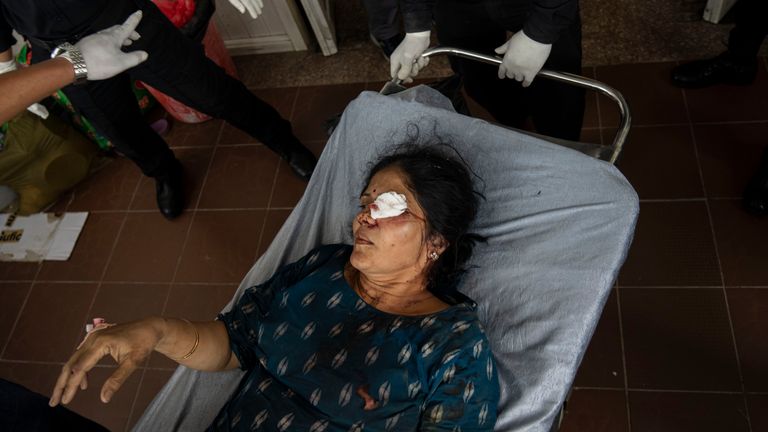 An injured woman is brought for treatment at a hospital, after a bus carrying Indian tourists fell into a river near Abukhaireni town about 75 miles west of the capital Kathmandu, Nepal, Friday, Aug. 23, 2024. (AP Photo/Niranjan Shrestha)