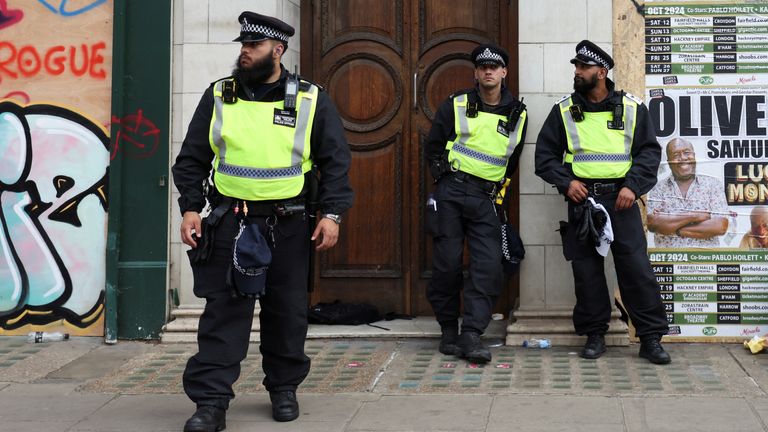Police officers stand guard during the Notting Hill Carnival. Pic: Reuters