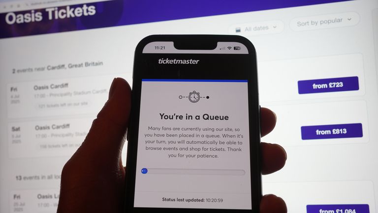 A person queues to access the Ticketmaster website on their phone, with the StubHub website in the background, showing detailed information about Oasis concert tickets on sale in London. Oasis fans in the UK and Ireland who missed out on the advance ticket sale will be looking to secure their spot at the band’s reunion concerts when they go on general sale on Saturday. Release date: Saturday 31st August 2024.