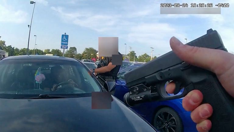 This still image from bodycam video released by the Blendon Township Police on Friday, Sept. 1, 2023, shows an officer pointing his gun at Ta'Kiya Young moments before shooting her through the windshield outside a grocery store in Blendon Township, Ohio, a suburb of Columbus, on Aug. 24.  The video was pixelated by the source. (Blendon Township Police via AP, File)