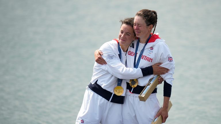 Britain's Emily Craig and Imogen Grant pose with the gold medal in the women's lightweight double sculls rowing final during a medals ceremony at the 2024 Summer Olympics, Friday, Aug. 2, 2024, in Vaires-sur-Marne, France. (AP Photo/Ebrahim Noroozi)