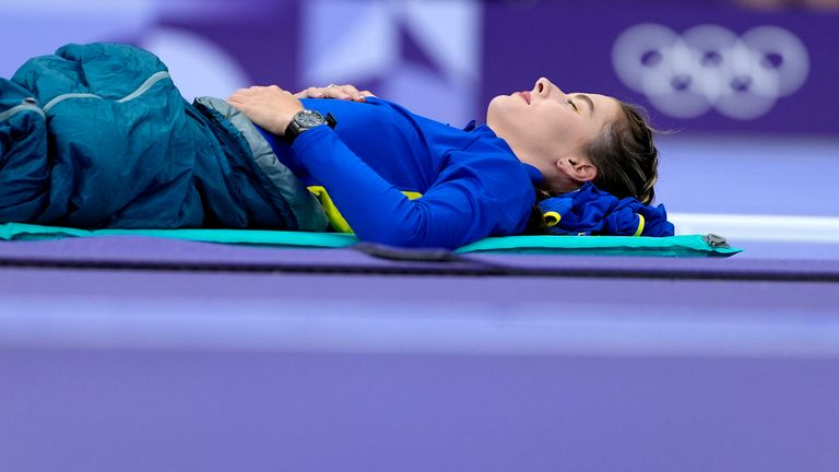 Yaroslava Mahuchikh, of Ukraine, rests before competing in the women's high jump final at the 2024 Summer Olympics, Sunday, Aug. 4, 2024, in Saint-Denis, France. (AP Photo/Matthias Schrader)