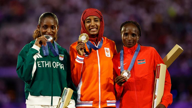 Gold medallist Sifan Hassan of Netherlands celebrates on the podium with silver medallist Tigst Assefa of Ethiopia and bronze medallist Hellen Obiri of Kenya. Pic: Reuters
