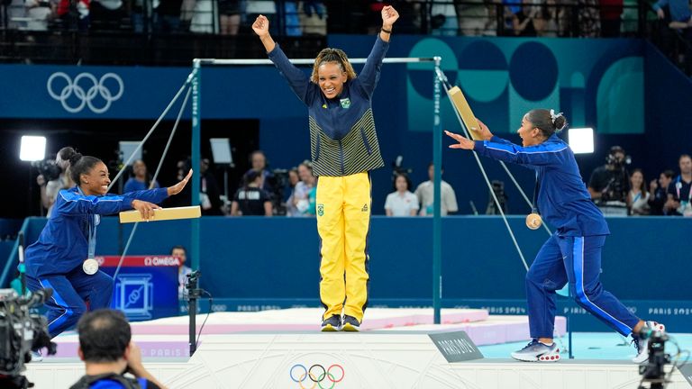 Aug 5, 2024; Paris, France; Simone Biles and Jordan Chiles bow to gold medalist Rebeca Andrade of Brazil on the floor exercise on day three of the gymnastics event finals during the Paris 2024 Olympic Summer Games. Mandatory Credit: Jack Gruber-USA TODAY Sports