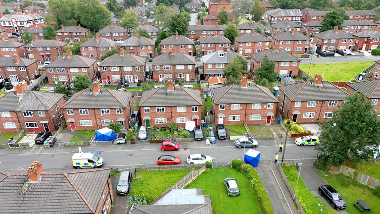 Greater Manchester police officers near a property in Barnard Road in Gorton.
Pic: PA