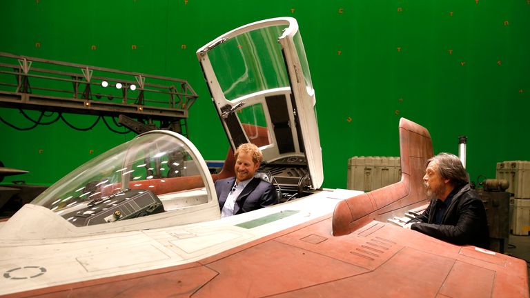 Britain's Prince Harry sits in an A-wing fighter as he talks with US actor Mark Hamill during a tour of the Star Wars sets at Pinewood studios in Iver Heath, west of London, Britain on April 19, 2016. Prince William, Duke of Cambridge and Prince Harry are touring Pinewood to visit the production workshops and meet the creative teams working behind the scenes on the Star Wars films. REUTERS/Adrian Dennis/Pool