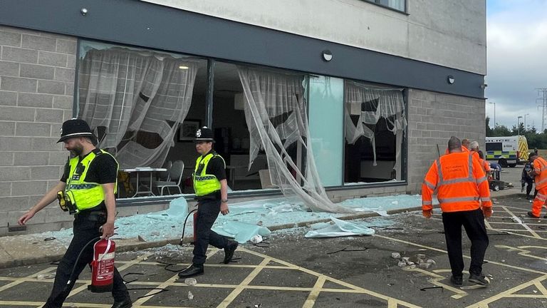 People clear debris at the Holiday Inn Express in Rotherham.
Pic: PA