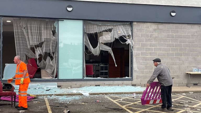 People clear debris at the Holiday Inn Express in Rotherham.
Pic: PA