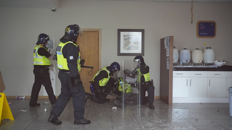 Officers tend to a wounded colleague inside the Holiday Inn. Pic: PA