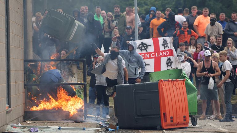 Rioters outside the hotel in Rotherham on Sunday. Pic: Reuters