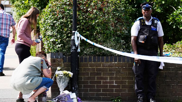 A police officer stands by a police cordon as members of the public lay tributes on Overbury Street, near the scene in Rushmore Road, Clapton.
Pic: PA