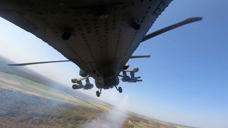 A Russian military helicopter fires following Ukraine's incursion. Pic: Reuters