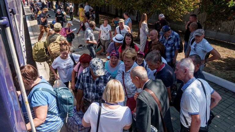 People stay in line for evacuation train in Pokrovsk, Donetsk region, Ukraine, Monday, August 19, 2024. Due to the advance of Russian troops, the war affects more and more new settlements to the west of the Donetsk region. Intensive shelling forced people to leave homes. (AP Photo/Evgeniy Maloletka)