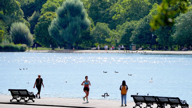 A runner runs through Hyde Park as temperatures are set to cool this week. Pic: PA