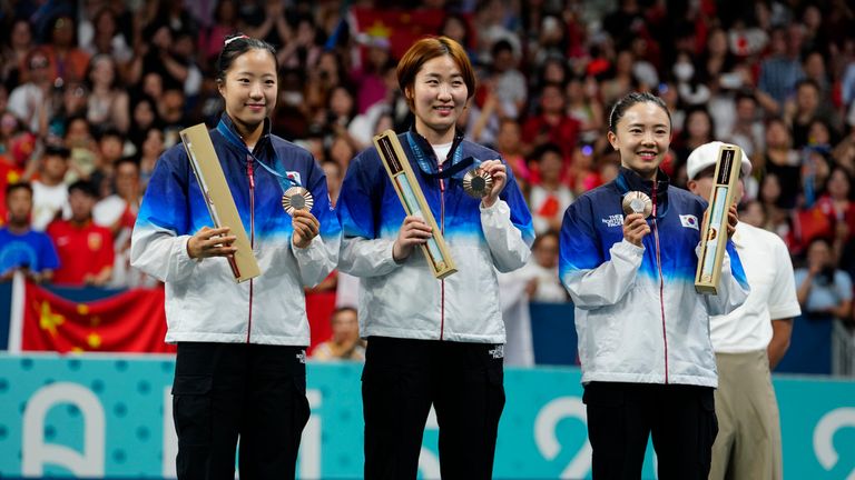 South Korean athletes with the bronze medals pose during the medal ceremony of the women's table tennis team match at the 2024 Summer Olympics, Saturday, Aug. 10, 2024, in Paris, France. (AP Photo/Petros Giannakouris)