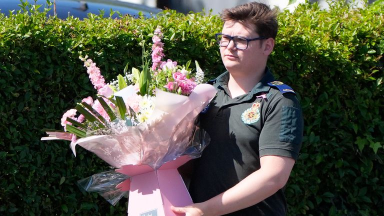 A paramedic carries flowers, ahead of the funeral of Southport stabbing victim Alice da Silva Aguiar at St Patrick's Church, Southport. The nine-year-old died in a knife attack at a dance class in Southport on July 29. Picture date: Sunday August 11, 2024.