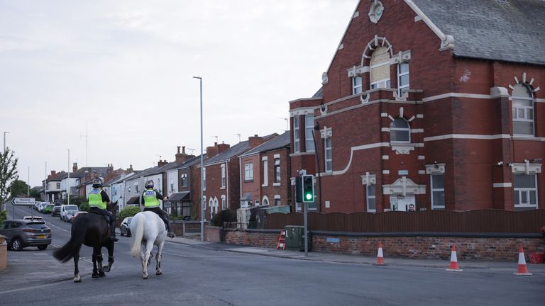 Mounted police patrol outside the Southport Islamic Centre Mosque in Southport, Merseyside, following a demonstration in which police officers suffered serious injuries when bricks, stones and bottles were thrown and cars were set on fire. This came during violent protests following a vigil for three girls killed in a knife attack at a Taylor Swift-style holiday club on Monday. Date taken: Wednesday July 31, 2024. PA Photo. Eight other children suffered stab wounds and five are in a critical condition, alongside two adults who were also seriously injured. A 17-year-old boy from Banks, Lancashire, has been arrested on charges of murder and attempted murder over the incident. See PA report POLICE Southport. Image credit: James Speakman/PA Wire