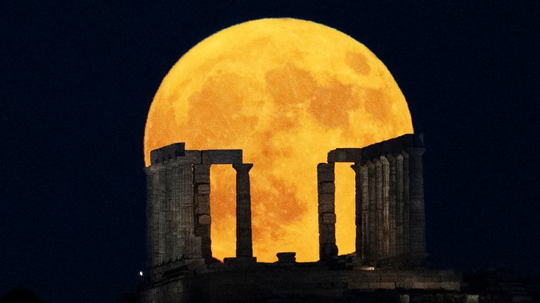 The moon rising behind the Temple of Poseidon in Greece. Pic: AP