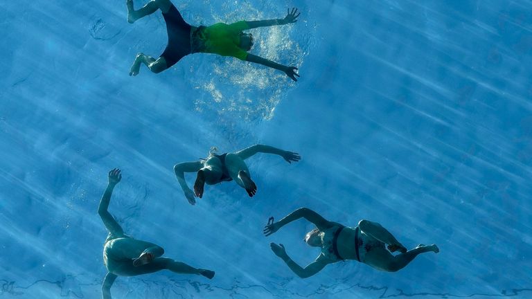 Swimmers and sunbathers enjoy the Sky Pool in London, Tuesday, July 30, 2024. Tuesday is expected to be the hottest day of the year in the UK so far, with temperatures reaching 32ºC. (AP Photo/ Frank Augstein)