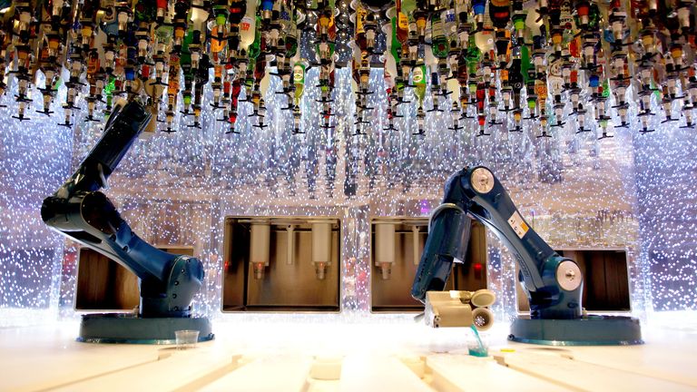 Robots serve drinks at the bionic bar on Royal Caribbean Cruises' world's largest cruise ship, the 362-meter-long Symphony of the Seas, during its world premiere ceremony in a port in Malaga, Spain, March 27, 2018 REUTERS/Jon Nazca