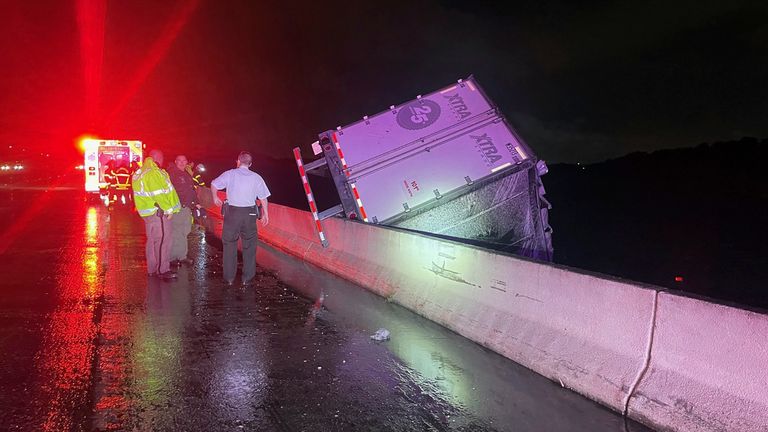 A tractor trailer dangles from a bridge on Interstate 75 near Tampa in Florida. Pic: AP