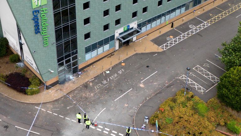 A drone view of police at the Holiday Inn Express in Tamworth, Staffordshire, after a mob attacked it on Sunday in what police said were "violent acts of thuggery." A large group of individuals were seen in the area of the Staffordshire town, with people seen throwing projectiles, smashing windows, starting fires and targeting police. Picture date: Monday August 5, 2024.
