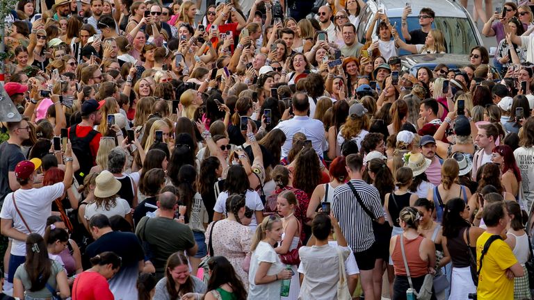 Swifties gather and sing in Vienna's city center on Thursday, Aug. 8, 2024. Organizers of three Taylor Swift concerts at Vienna Stadium this week canceled them Wednesday after officials announced arrests over a apparent plot to launch an attack against an event in the Vienna area such as the concerts. (AP Photo/Heinz-Peter Bader)