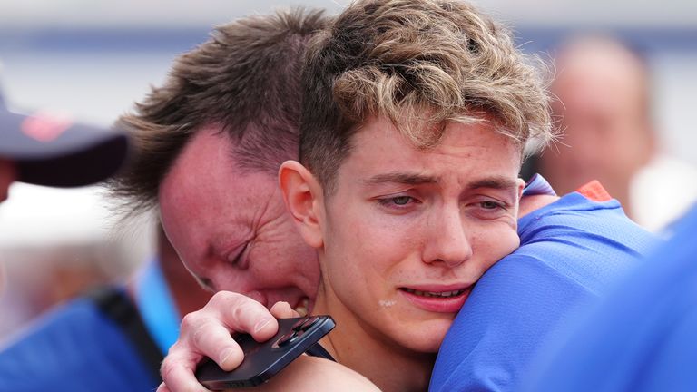 Toby Roberts celebrates with dad Tristian after winning gold.
Pic: PA