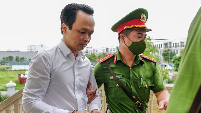 Trinh Van Quyet (L) is escorted to court. Pic: AP
