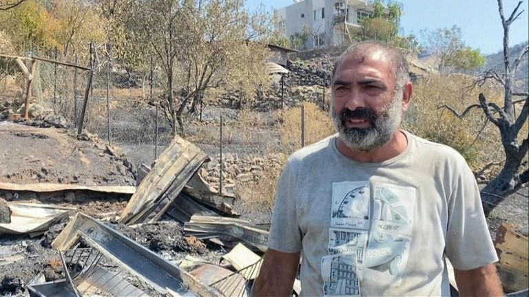 Abdullah Ozata among the wreckage left by wildfires