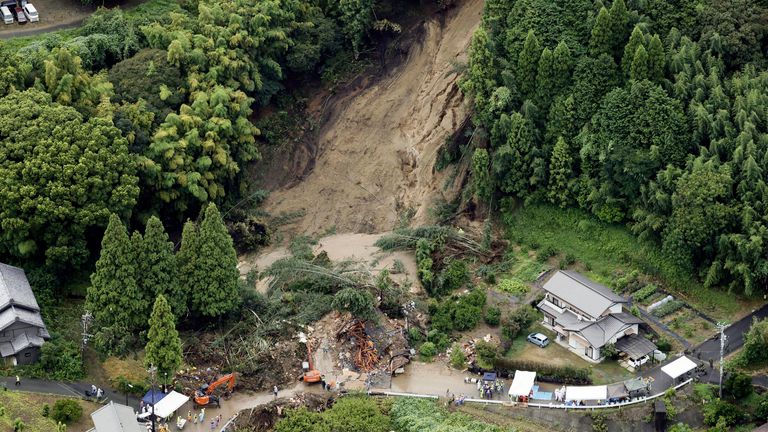 This aerial image shows the landslide in Gamagori, Aichi prefecture, Japan, Wednesday, Aug. 28, 2024. Ahead of the typhoon's arrival, heavy rain caused a landslide that buried a house in the central city of Gamagori.  (Kyodo News via AP)