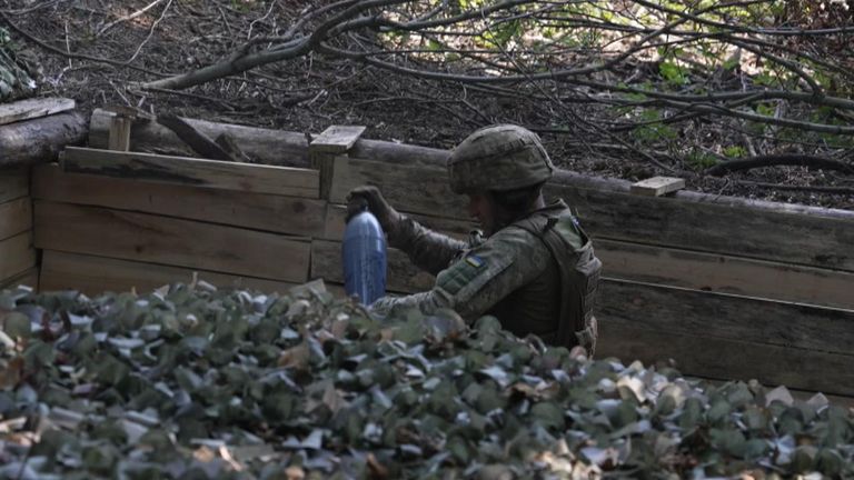 A soldier loading a mortar