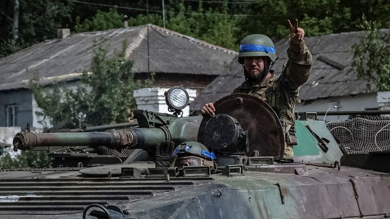 A Ukrainian serviceman riding in an infantry fighting vehicle near the Russian border. Pic: Reuters