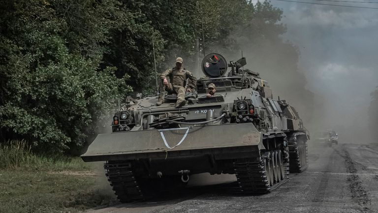 Ukrainian servicemen ride a military vehicle near the Russian border. Pic: Reuters