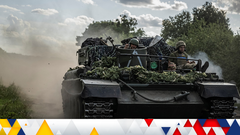 Ukrainian servicemen ride a military vehicle, near the Russian border in Sumy region. Pic: Reuters