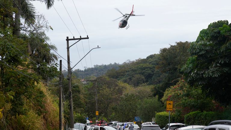 A helicopter flies close to the crash site. Image: AP