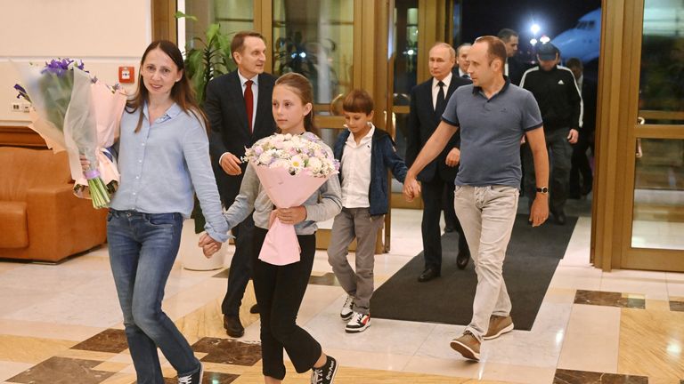 Vladimir Putin walks behind Russian nationals Artyom Dultsev, Anna Dultseva and their children following a prisoner exchange between Russia with Western countries.
Pic:Sputnik/Reuters