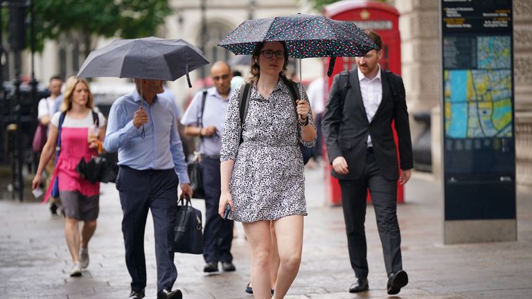 People walking in the rain in Whitehall, Westminster, London.  Thunderstorms and hail are expected to hit parts of the UK on Thursday as temperatures reach 30C.  Photo date: Thursday, August 1, 2024.