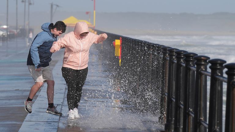 People enjoy the windy conditions and the waves in Tramore in County Waterford. The "remnants" of Hurricane Ernesto are set to batter parts of the UK in the week ahead, bringing heavy rain and wind gusts of up to 60mph, the Met Office has warned. Picture date: Monday August 19, 2024. PA Photo. See PA story Weather Hurricane. Photo credit should read: Niall Carson/PA Wire