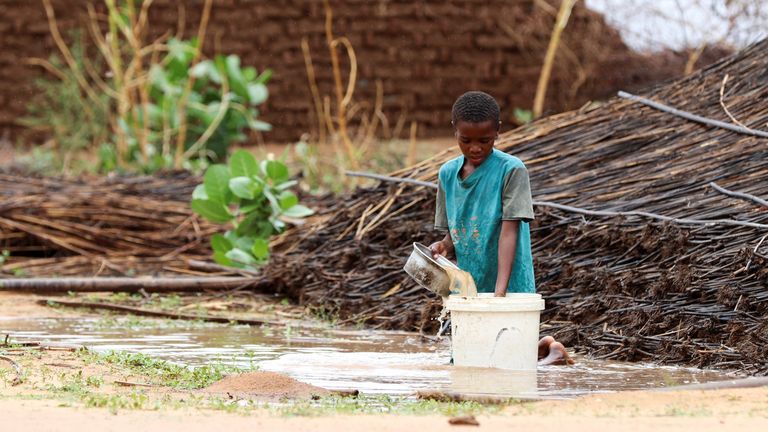 A displaced Sudanese child pours water at Zamzam camp, in North Darfur, Sudan, August 1, 2024. REUTERS/Mohamed Jamal Jebrel