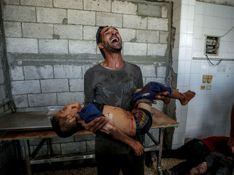 A Palestinian man mourns the loss of a relative in this week's attacks. Pic: AP