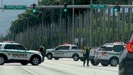 Police patrol the area following reports of multiple shots fired near Donald Trump's golf course. Pic: X/@realDerekUtley via Reuters