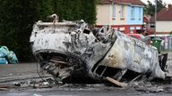 Cars were set alight during the unrest. Pic: PA