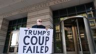 A protester holds a placard outside a federal courthouse in Washington. Pic: AP